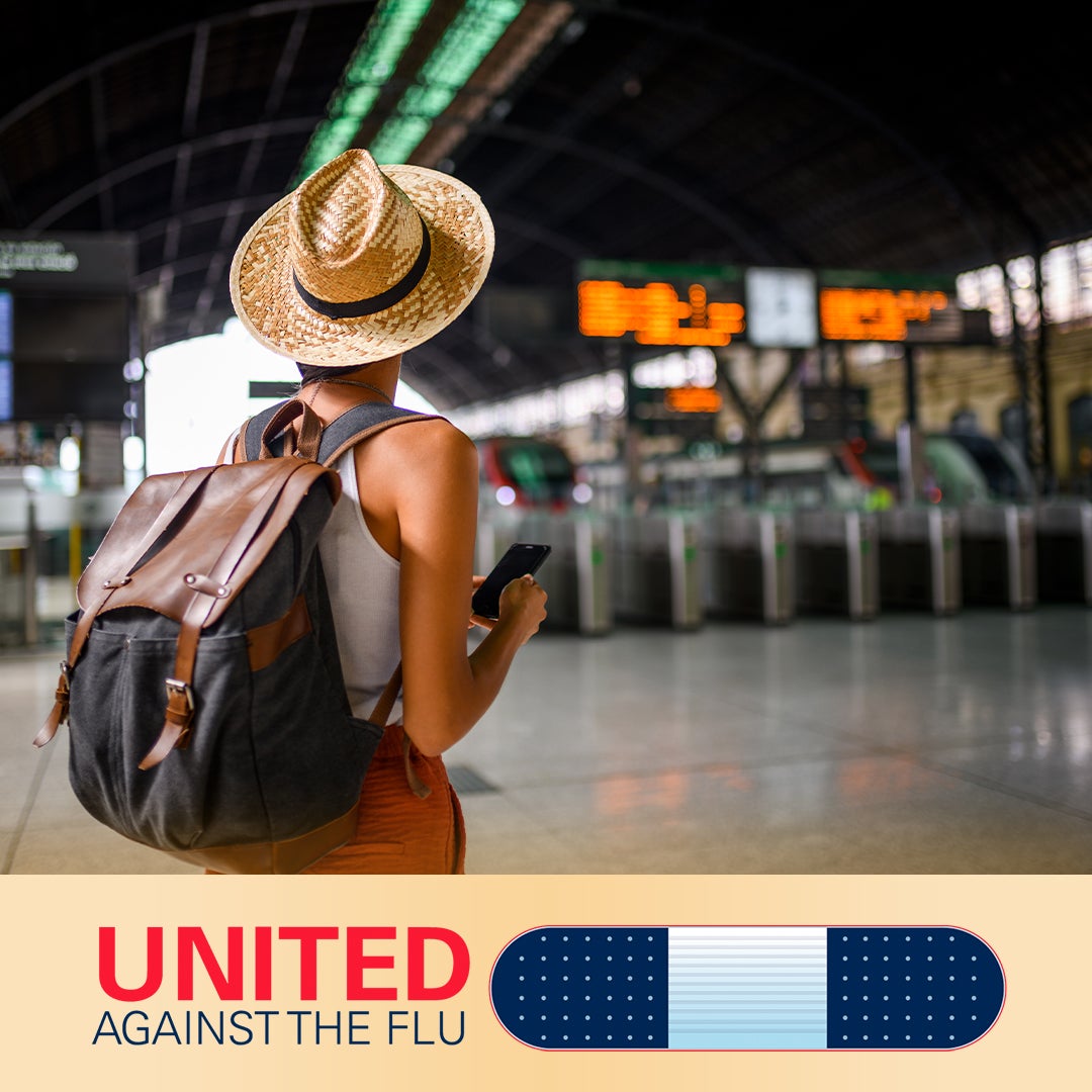 united against the flu logo below image of female traveler wearing backpack and straw fedora, standing in a train station