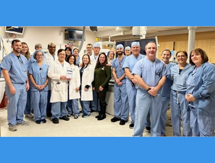 Catholic Medical Center. CMC pacemaker team stands gathered in a room for photo.