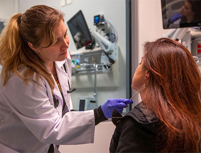 Vanderbilt University Medical Center - Stock photo of female clinician swabbing female patient's neck