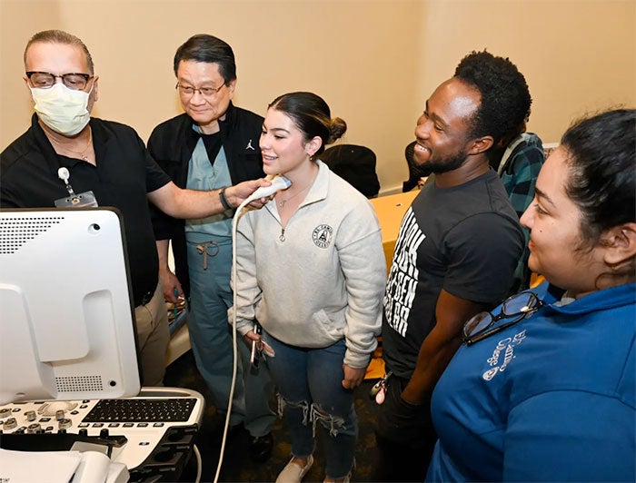 Torrance Memorial Medical Center. A group of students stands watching a demonstration and Career Exploration Day