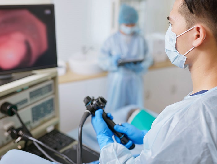 M Health Fairview. Stock image of a Clinician watching a screen showing scope of internal organs