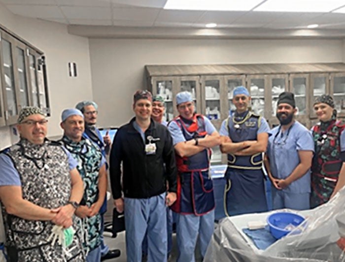 HCA Florida. Dr. Saurabh Sanon and cardiology team at HCA West Florida stand posed in operating room