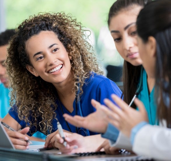 Medical person smiling while taking notes