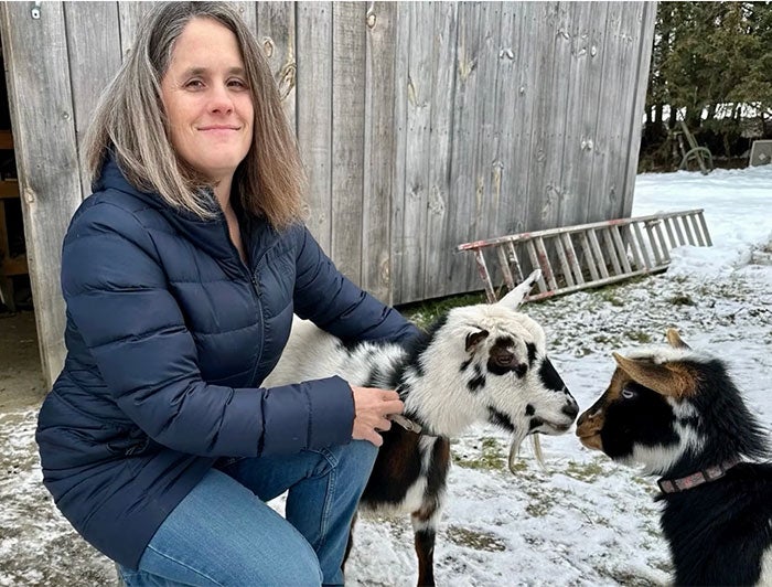 Gifford Health Care. nurse Jamie Cushman with goats on her family farm