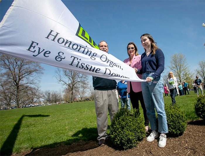 Penn State Health. Donate Life flag is unfurled at the flag raising ceremony.