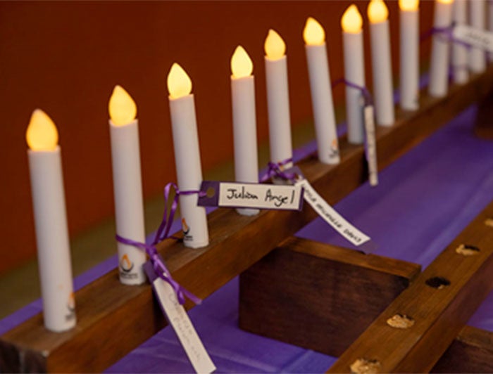 Penn Medicine. Memorial candles bear names tied on with purple string