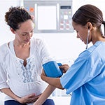 Nurse taking blood pressure reading
