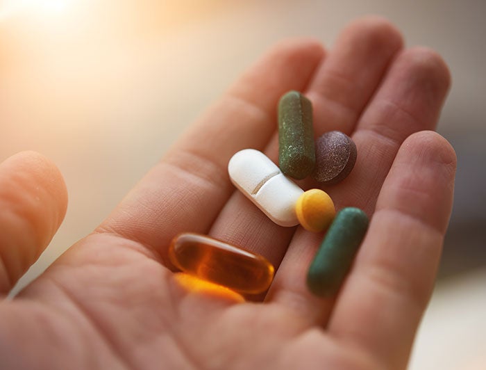 Atlantic Health. Stock image of open palm holding pills