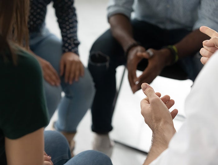 Hartford HealthCare. Stock image of people sitting together - close-up of hands 