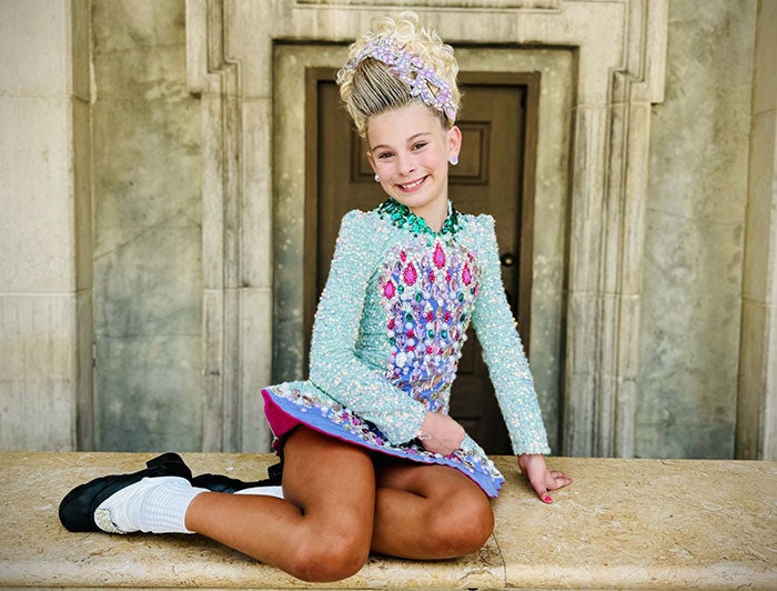 Nemour’s Children’s Hospital. Kieva sits smiling in her Irish dancing costume