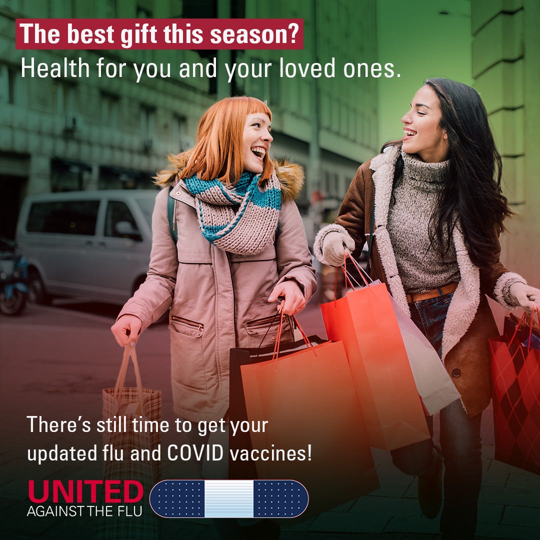 united against the flu logo below image of Two women in winter coats walking a city street holding shopping bags. Text: The best gift this season? Health for you and your loved ones. There's still time to get your updated flu and COVID vaccines!