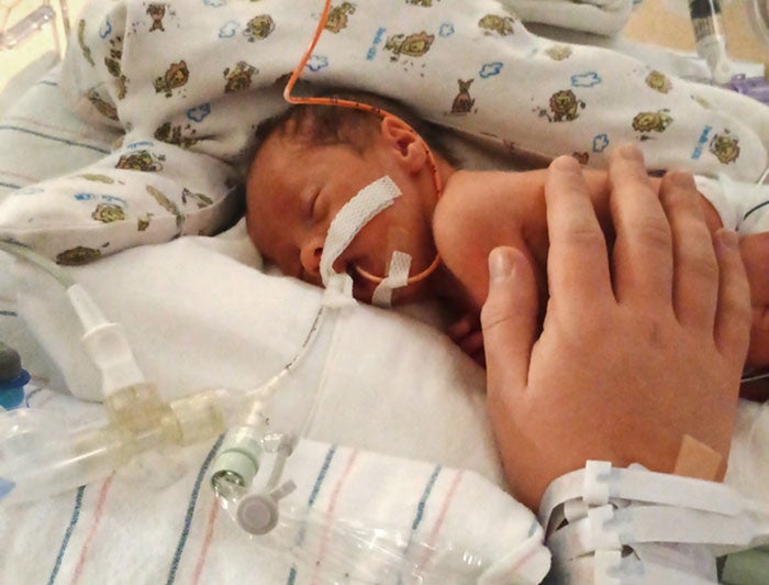 Banner - University Medical Center Phoenix. One of the Vargas quadruplets rests in a bassinet.