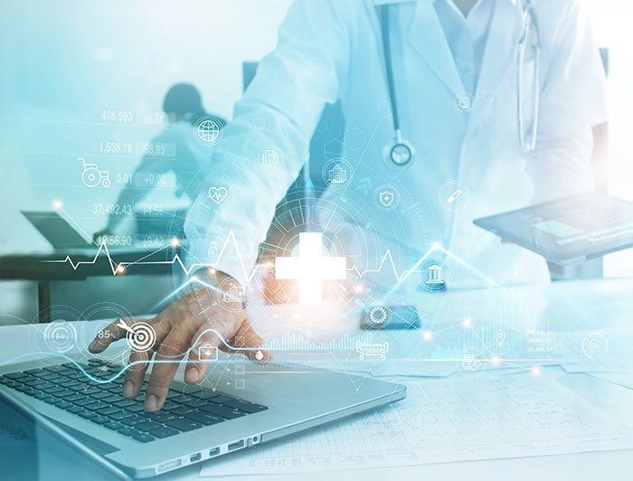 Our Lady of the Lake Ascension. Composite image shows a physician in white coat typing on a laptop, overlaid with futuristic tech symbols.