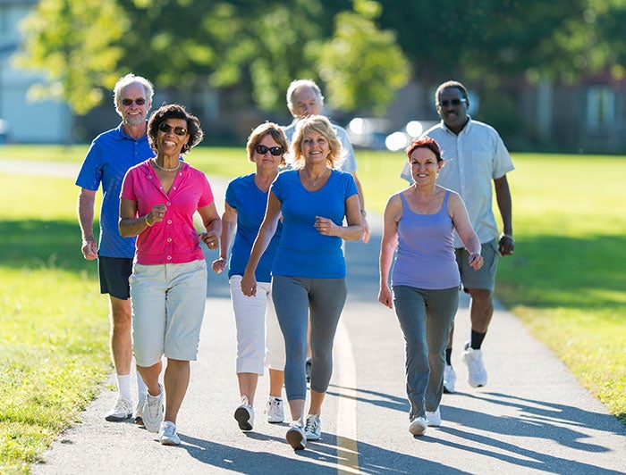 UW Medicine. A group of older adults walks on an outdoor track