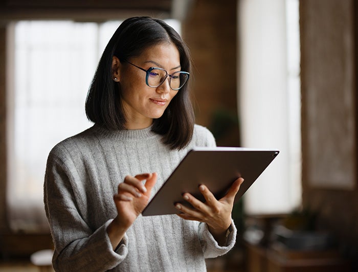 Telling the Hospital Story: Cedars-Sinai’s AI tool offers 24/7 patient support, shows promising results; stock image of a woman working on a tablet computer