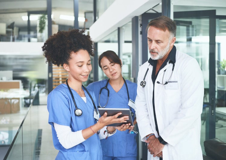 Medical staff in hall looking at tablet
