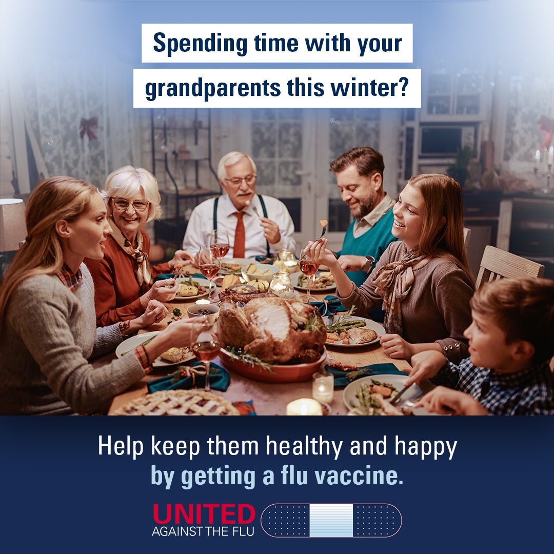 A multigenerational family gathers around a holiday meal of turkey and sides. Text: Spending time with your grandparents this winter? Help keep them healthy and happy by getting a flu vaccine. United Against the Flu