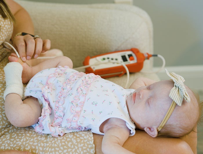 Newborn baby being examined at home; Telling the Hospital Story: Nemours Children’s Health redefines pediatric care with at-home model