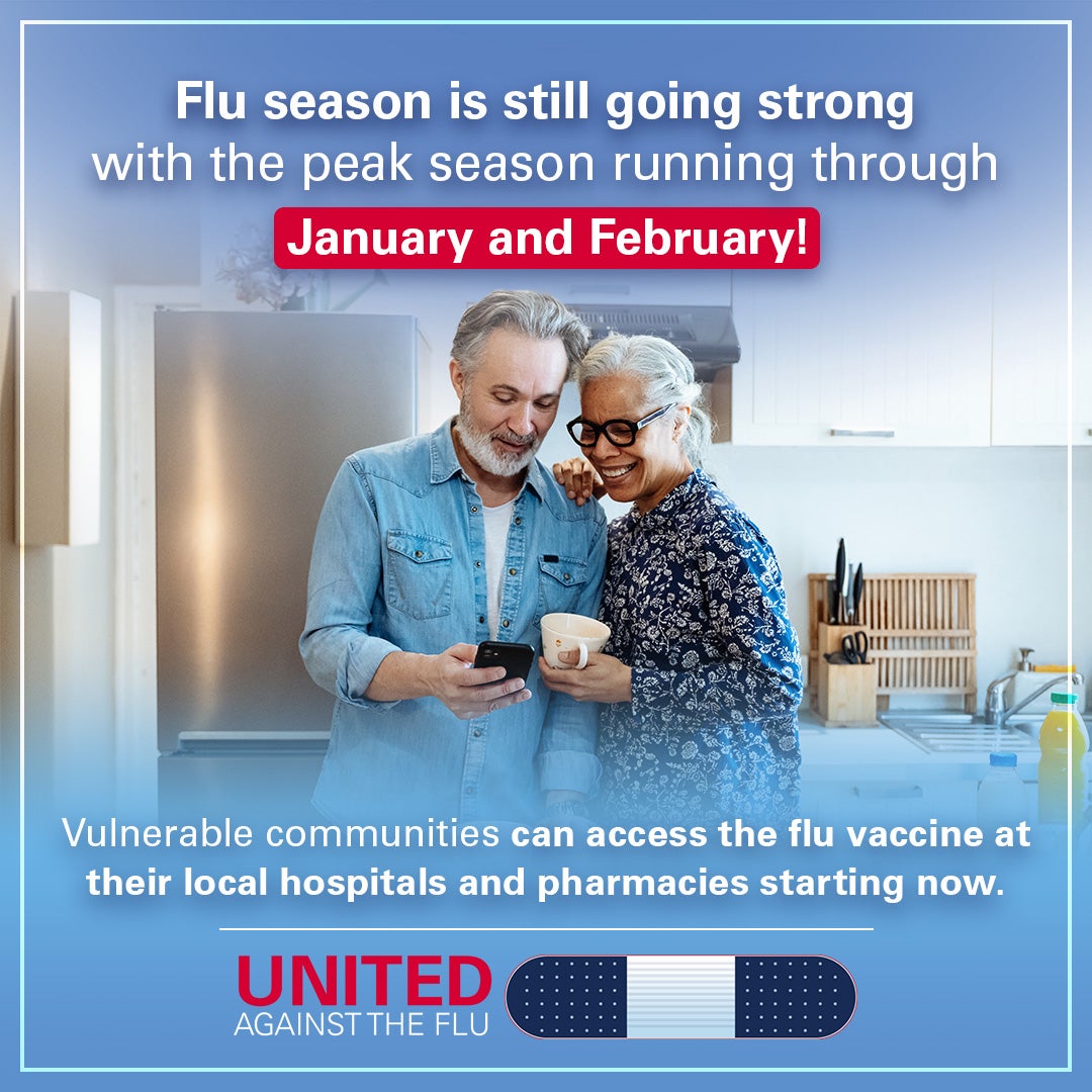 A grey-haired couple stands in their kitchen looking at a smartphone. Text: Flu season is still going strong with the peak season running through January and February! Vulnerable communities can access the flu vaccine at their local hospitals and pharmacies starting now. United Against the Flu.
