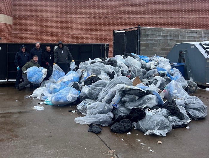 Grundy County Hospital maintenance team poses with bags of trash