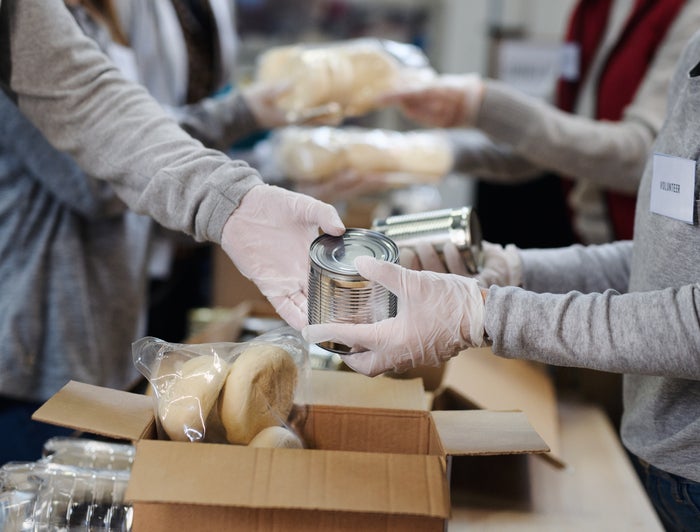 workers pack canned goods into boxes
