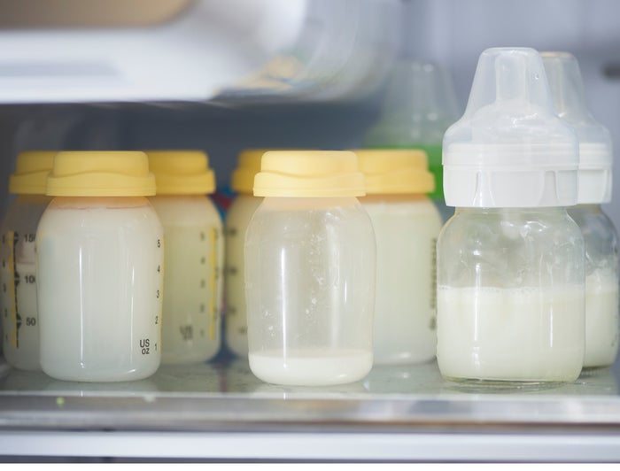 Bottles of expressed breast milk in a refrigerator