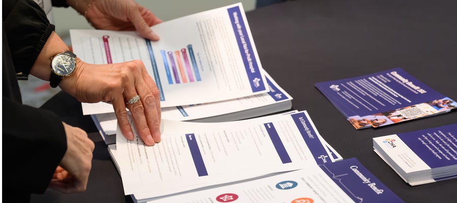image of hands flipping through pages of formal document