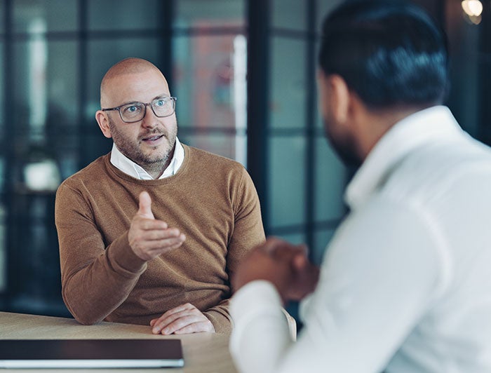 men sitting in a conference room talking