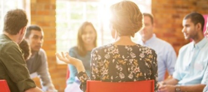 National Rural Health Day Behavioral Health image: A group of people of difference ages siting around a table talking.