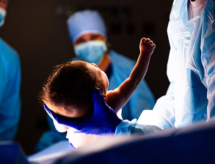 doctor holds a newborn