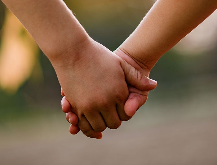 close-up of children holding hands