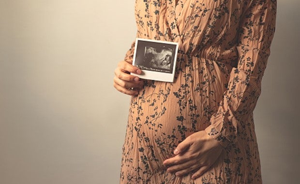 3 Ways Hospitals Are Tackling Maternal Health Innovation. A pregnant mother holding a fetal ultrasound image.