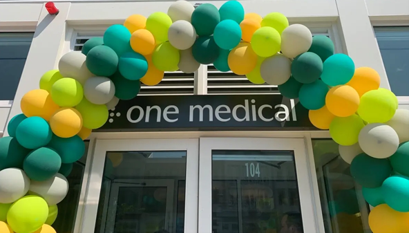 Amazon’s One Medical Ramps Up Its Expansion in Primary Care. A One Medical storefront with an arch or balloons over the doorway.
