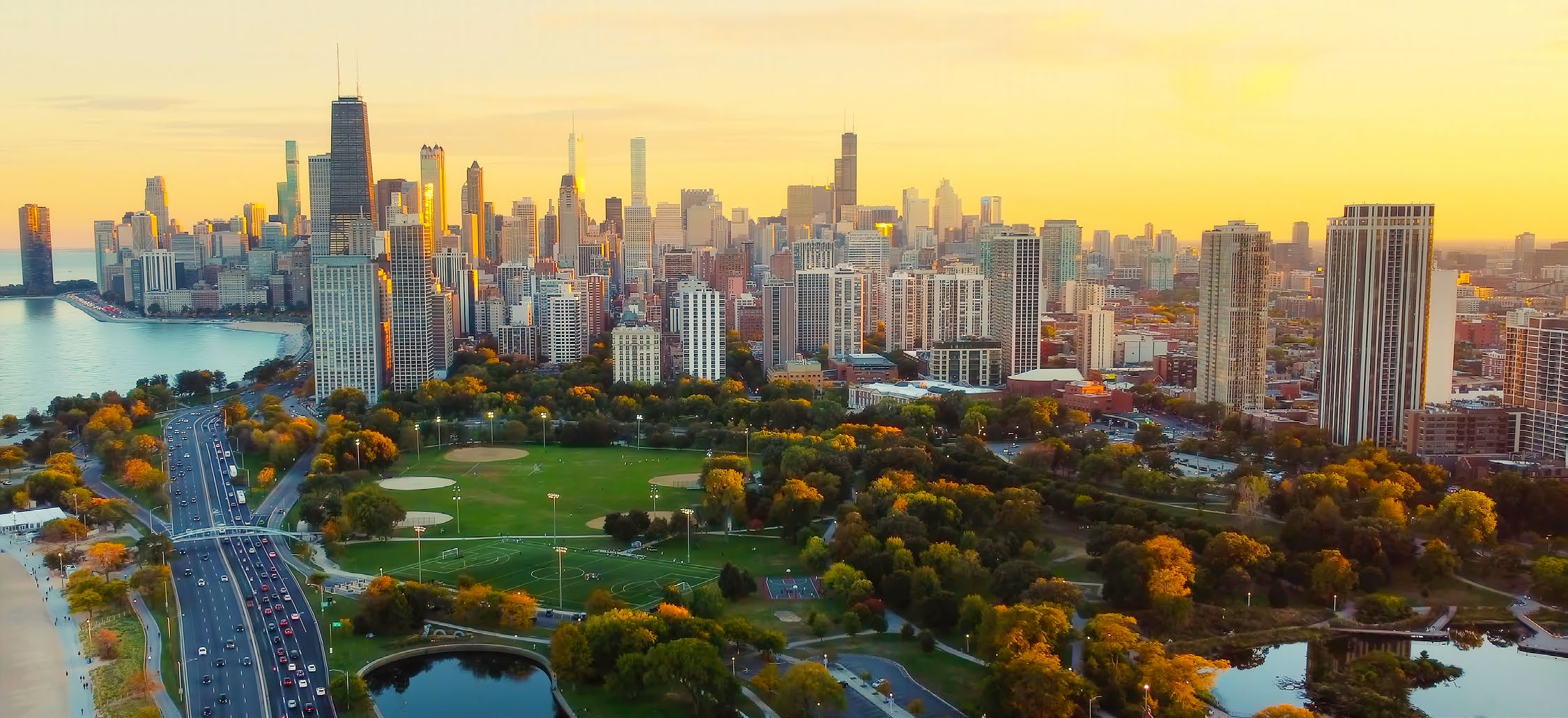 Chicago, Illinois. Lincoln Park is in the foreground with Lake Michigan and Lake Shore Drive to the left.