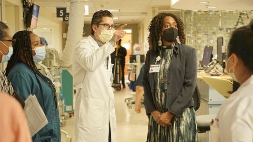 Dr. Ezike talks with Dr. Jaime Moreno, Chair of Emergency Medicine, and his team in the ER at Mount Sinai Hospital