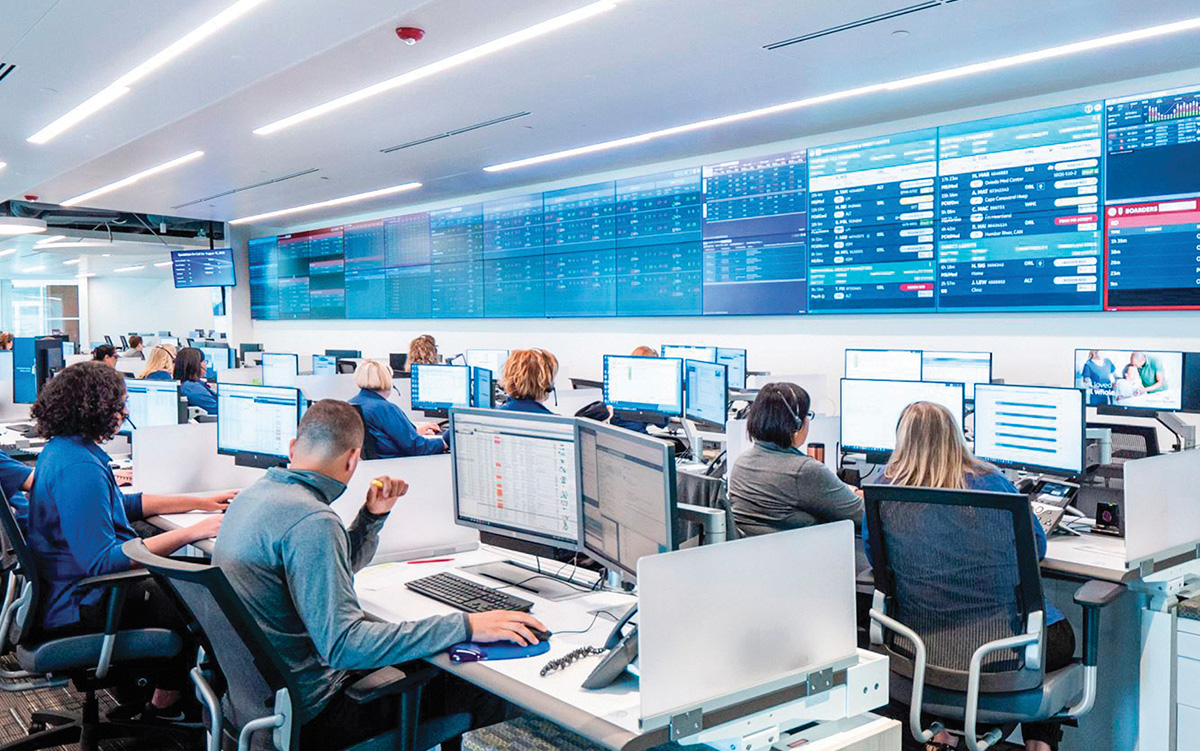 How Hospital Command Centers Streamline Patient Flow: 5 Proven Strategies. A group of hospital analysts sit in a hospital command center overseeing operations.