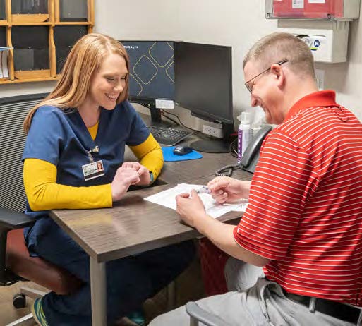 A Monument Health clinician teaches a patient how to properly inject his prescription medication.