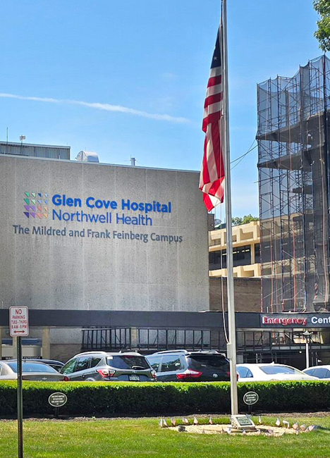 Northwell Glen Cove (New York) Hospital. The Mildred and Frank Feinberg Campus building with the United States flag flying in front of it.