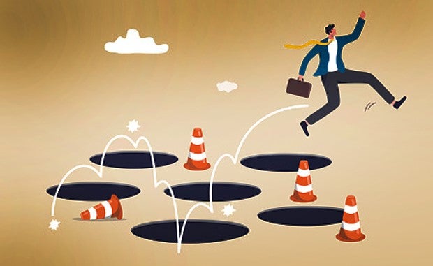 Partnership Trends and 4 Mistakes to Avoid During Negotiations. A business jumps around an area of holes identified with caution cones without falling in to any of the holes.