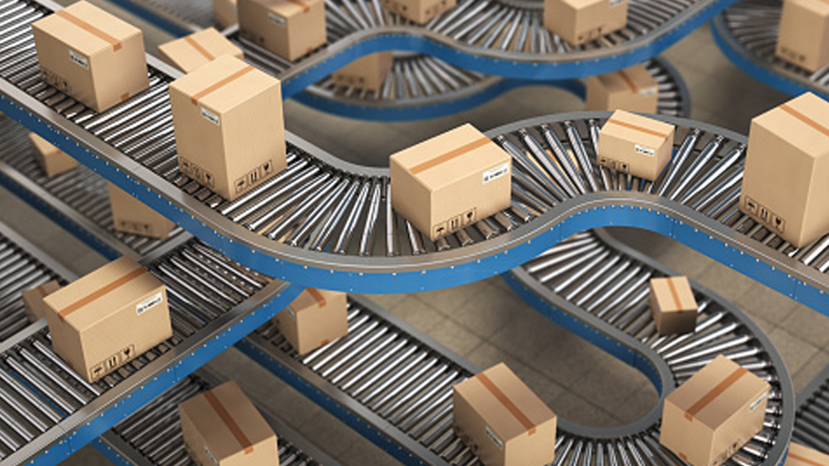 Returning to Normalcy Is Anything but for the Health Care Supply Chain. A factory floor with shipping boxes on multi-levels of roller conveyors.