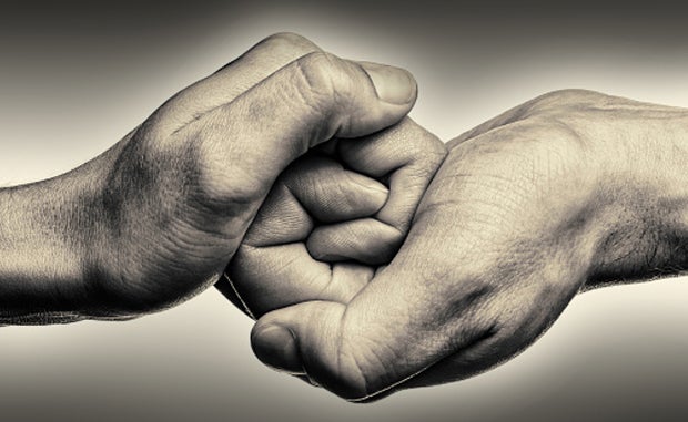 Preparing For Behavioral Health’s Future. A black and white image of two hands linked together. 