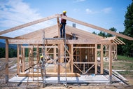 Study: Housing for Health Program Generates Significant Social Value and ROI. A construction crew frames a house.