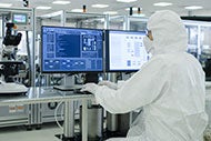 Technology Worker in Clean Suit Performing Research and Development