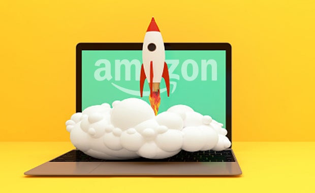 AWS Taps 10 Health Care Startups for Inaugural Accelerator Program. A rocket takes off from a laptop computer keyboard with the Amazon logo on the laptop monitor.