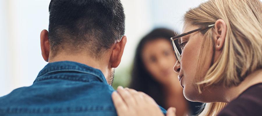 May is Mental Health Awareness Month. Man comforted during behavioral health counseling therapy.