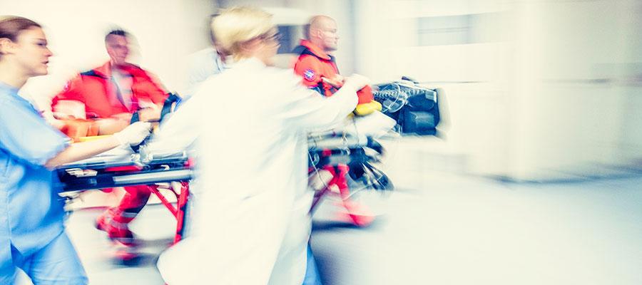 ER team rushing a patient on a gurney 