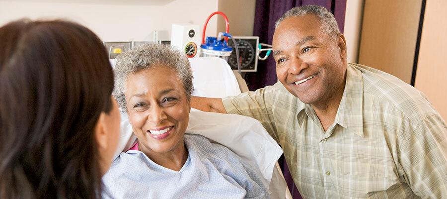 Image of family in hospital room, smiling