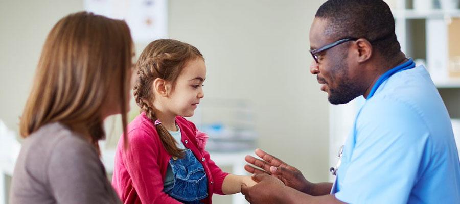 pediatric doctor nurse holding childs hand