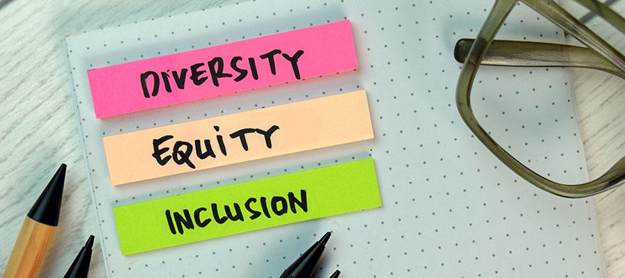 desk with small notes for diversity equity inclusion