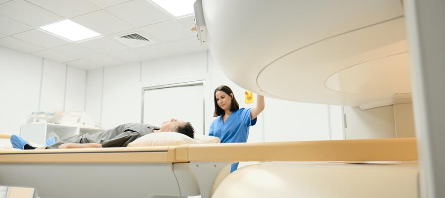 Woman manages MRI machine with male patient